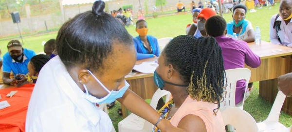 A woman receives her first COVID-19 vaccine in Hoima, Uganda. — courtesy John Kibego