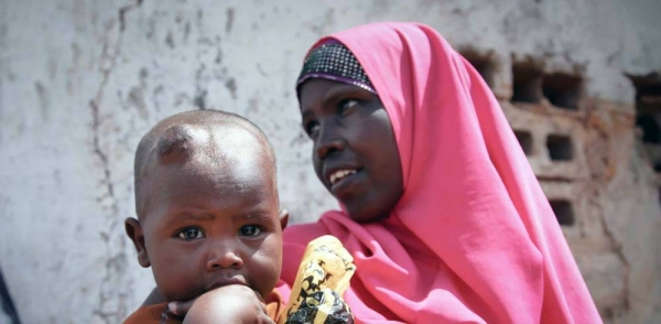 A women and her young child wait outside a free medical clinic in Kismayo, Somalia. — courtesy UN Photo/Ramadan Mohamed Hassan