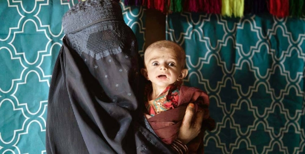 Mother brings her severely malnourished 7-month-old baby to a mobile health and nutrition team in a village at Maiwand District of Kandahar province, Afghanistan. — courtesy UNICEF/ Alessio Romenzi