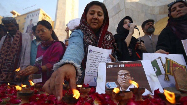 People in Pakistan hold a vigil for Priyantha Diyawadanage on Sunday.