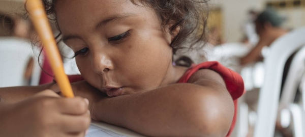 Yulis Rivas draws a picture of her parents in the Friendly Space in Cucuta, Colombia, where UNICEF provides learning activities for migrant children and parents from Venezuela.
