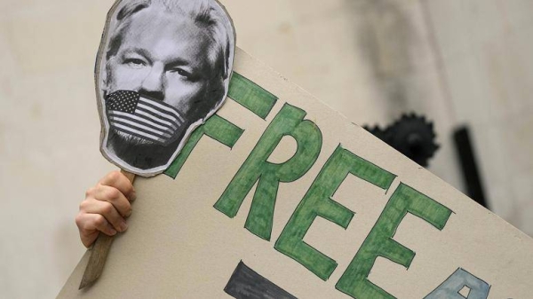 Supporters stage a demonstration in support of Julian Assange, outside the High Court in London, Wednesday, Oct. 27, 2021.