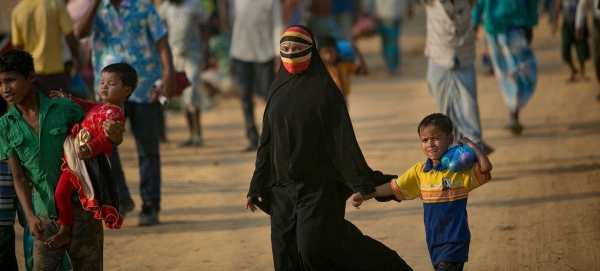 A woman walks through a market in a Rohingya refugee camp in Cox's Bazar, Bangladesh.