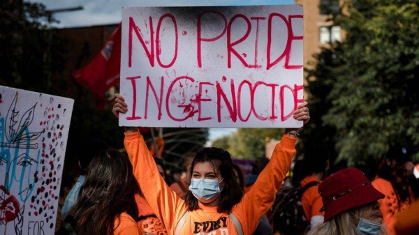 A woman holds a placard during the 