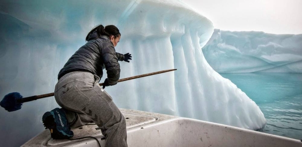 A fisherman tries to prevent his fishing net being dragged down by an iceberg in the Greenland sea. — courtesy Climate Visuals Countdown/Turpin Samuel