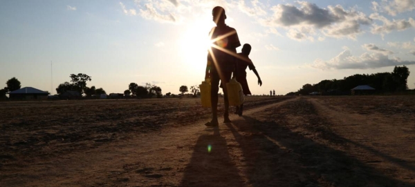 Two children carry water in Leer, Unity State in South Sudan, parts of which have been declared as famine-affected.