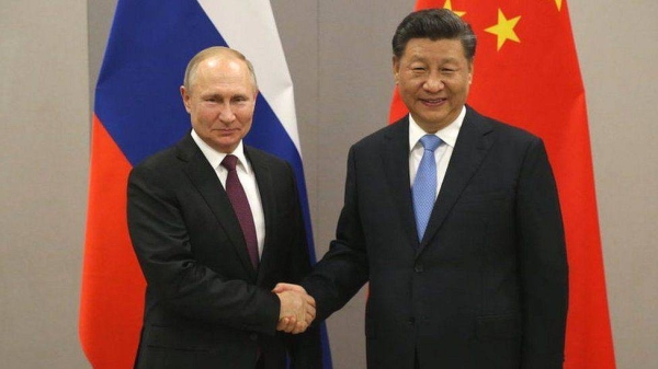 Russian President Vladimir Putin (L) greets Chinese President Xi Jinping (R) during their bilateral meeting on November 13, 2019 in Brasilia, Brazil.