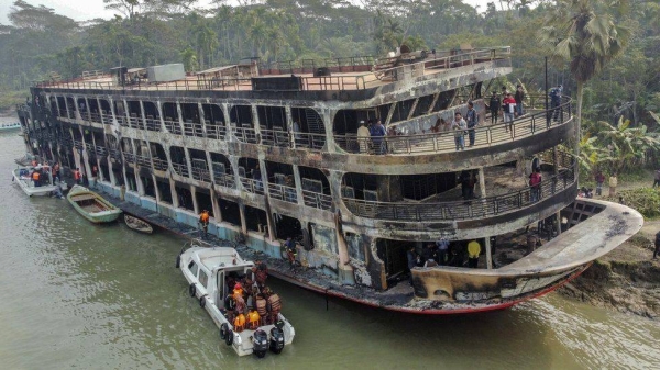 Firefighters and coast guard personnel at the scene of a passenger ferry that caught fire near the southern rural town of Jhalakathi, south of Dhaka in Bangladesh, on Friday.