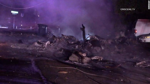 The wreckage of a plane crash covers a street in El Cajon, California.