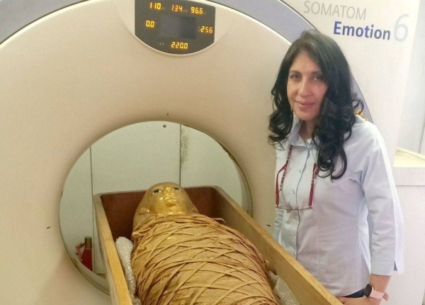 Dr Sahar Saleem, professor of radiology at Cairo University's Kasr Al-Ainy Faculty of Medicine, stands next to the mummy of Amenhotep I and a CT scanner.