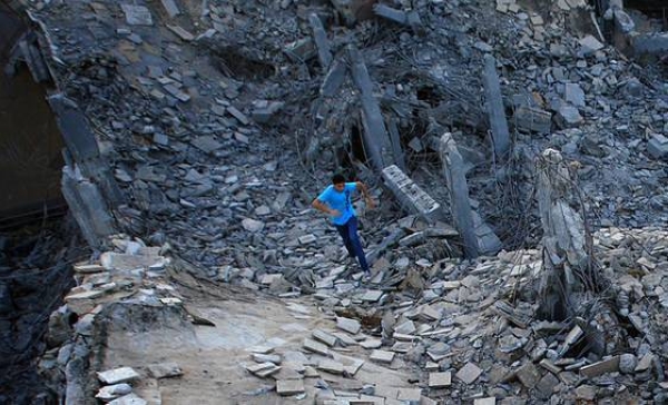 A boy runs in the ruins of the Bab al-Aziziyah compound in Tripoli, Libya.
