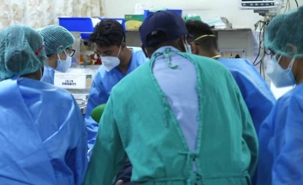 Indian medical professionals attend to patients inside a Delhi hospital, which ran low on beds and oxygen during the brutal second wave.