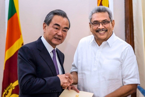 Sri Lanka's President Gotabaya Rajapaksa (R) shakes hands with Chinese Foreign Minister Wang Yi during a meeting in Colombo. (File)