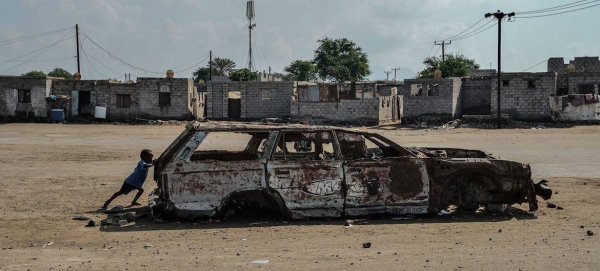 A young boy with a burned-out car is evidence of the intense fighting in 2015, when Houthi forces were driven out of the city in fierce fighting for the 'Battle of Aden'.