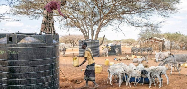 A man collects water from a water tank in Kenya. — courtesy FAO/Patrick Meinhardt