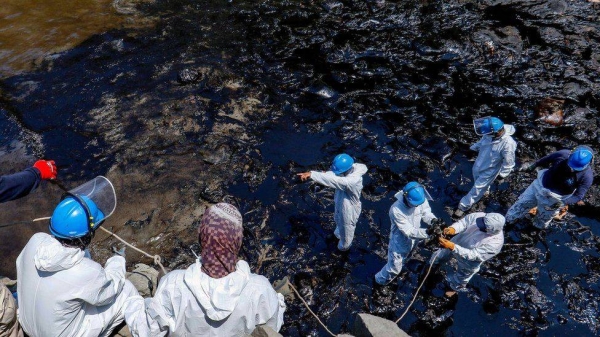 Workers clearing up an oil spill on a Peruvian beach.