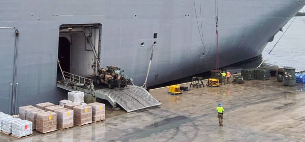 Workers load the HMAS Adelaide ship with emergency supplies dedicated to Tonga Islands in response to the eruption of the Hunga-Tonga-Hunga-Ha'apai underwater volcano. — courtesy UNICEF/Sarah Shotunde