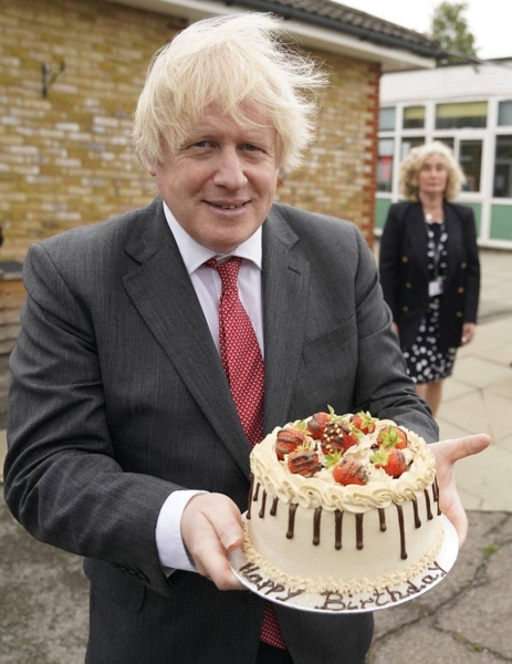 Prime Minister Boris Johnson holds up his birthday cake as he visits Bovingdon Primary Academy in Hertfordshire.
