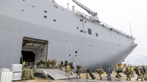 Australian Defence Force (ADF) personnel embarking onto HMAS Adelaide at the Port of Brisbane, Queensland.