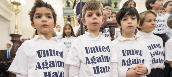 Children wearing “United Against Hate” t-shirts appear at an interfaith gathering at the Park East Synagogue in New York City in memory of Jewish worshipers who were killed in Pittsburgh in the United States.