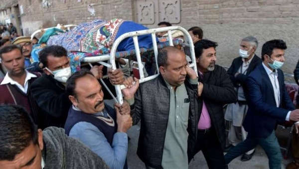 Christian mourners carry the coffin of a priest who was gunned down when driving back home after Sunday prayers in Peshawar on January 30, 2022.
