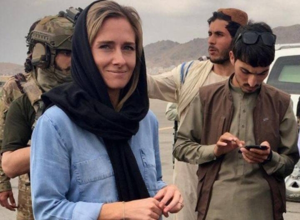 Journalist Charlotte Bellis with Taliban officials at Hamid Karzai International Airport in Kabul.