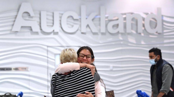 Passengers from Australia are greeted by friends and relatives at Auckland Airport, New Zealand.