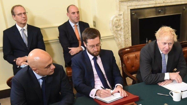 Martin Reynolds and Dan Rosenfield — pictured here behind the PM — are two of the senior staff members to resign