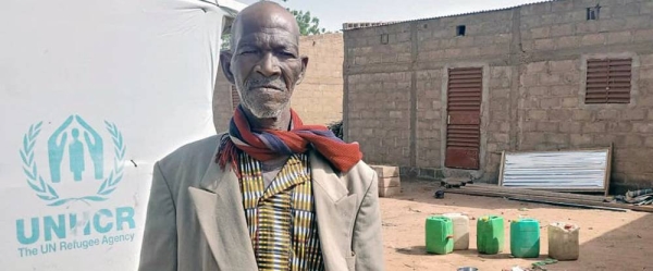 Lambda stands in his compound in the commune of Tougouri, northern Burkina Faso. — courtesy UNHCR/Barry YN Maxime