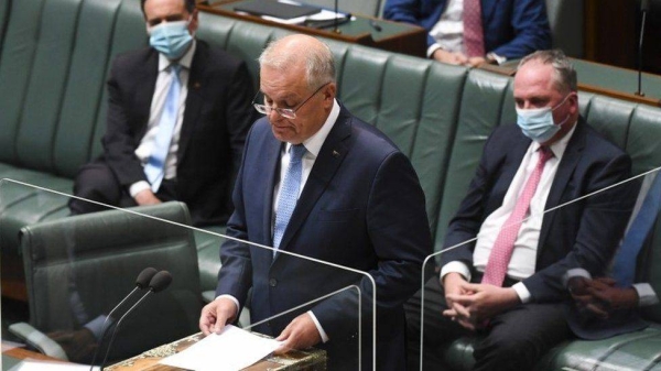 Scott Morrison reading the apology in parliament on Tuesday.
