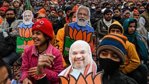 Bhartiya Janata Party (BJP) supporters listen to a speech of India's Home Minister and BJP leader Amit Shah during an election rally in Loni, Ghaziabad district of Uttar Pradesh.