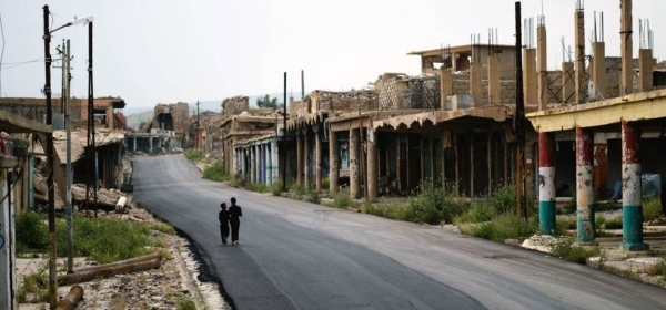 Iraqi children walk past a marketplace in Sinjar which was ruined in the war with the Daesh terrorist network.