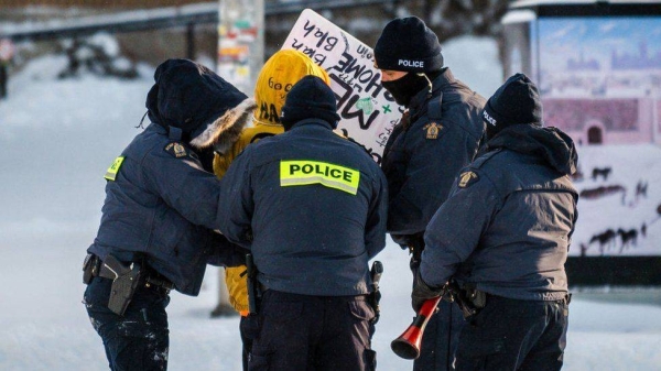 A demonstrator is arrested by police in Ottawa on February 18, 2022, as they begin to remove protesters demanding an end to Covid-19 mandates.