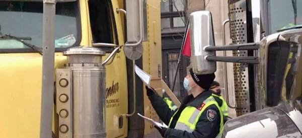 Police arrested scores of demonstrators and towed away vehicles Friday in Canada's besieged capital, and a stream of trucks started leaving under the pressure, raising authorities' hopes for an end to the three-week protest against the country's COVID-19 restrictions.