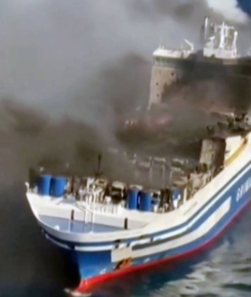 The young man of 21, center, who said he comes from Belarus was located at the stern of the Euroferry Olympia in apparently good condition. He was reported missing on the Italian ferry on fire off the Greek island of Corfu has been found alive and rescued.