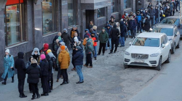 People stand in line to use an ATM money machine in Saint Petersburg, Russia, February 27.