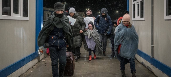 A Ukrainian refugee family with eleven children enter Romania at the Isaccea border crossing.