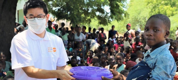 Yankho Alufandika (L) chats with her friend after receiving dignity kits. — courtesy UNFPA/ Joseph Scott