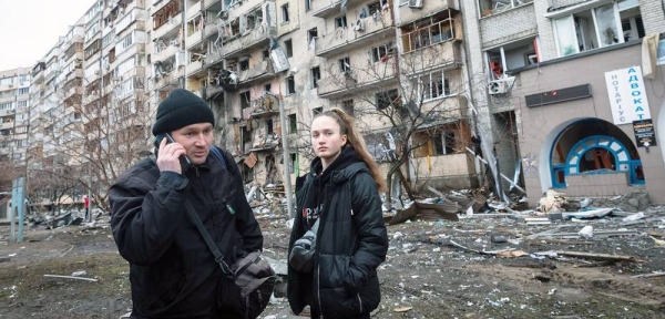 On Feb. 25, 2022 in Kiev, Ukraine, a man calls relatives, standing in front of an apartment building heavily damaged during the ongoing Russian invasion. — courtesy UNICEF/Anton Skyba for The Globe and Mail