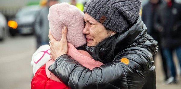 A woman holds her child as she arrives in Berdyszcze in Poland, after crossing the border from Ukraine. — courtesy UNICEF/Tom Remp