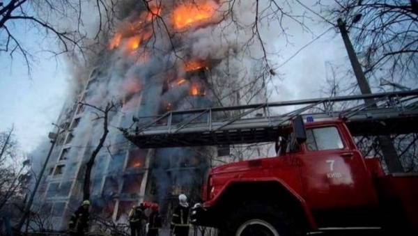 Two people were killed in an attack on an apartment block in Kyiv, emergency services say.