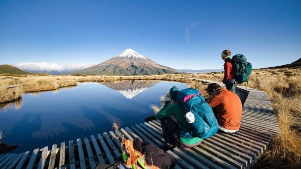 Tourists enjoy the view of Mount Taranaki in New Zealand.