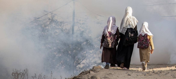 Three sisters walk to their school close to a fighting zone in Taiz, Yemen, February 2021.