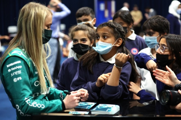 Jessica Hawkins, Development Driver, Aston Martin, signs autographs for school children during the Saudi Arabian GP at Jeddah Street Circuit on Thursday March 24, 2022 in Jeddah, Saudi Arabia. (Photo by Glenn Dunbar / LAT Images)