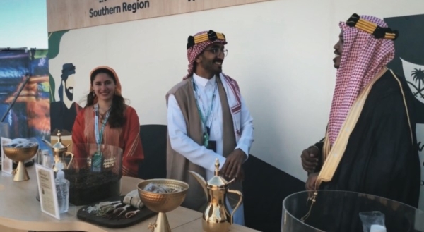 Young Saudi men and women in the Saudi Coffee booth in Saudi cultural costumes from all regions of the Kingdom who draw, through their welcome and smiles, all the guests to visit the booth.