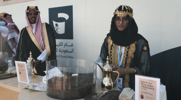 Young Saudi men and women in the Saudi Coffee booth in Saudi cultural costumes from all regions of the Kingdom who draw, through their welcome and smiles, all the guests to visit the booth.