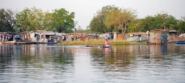 An ex-farmer displaced by flooding, paddles his canoe from his home in Old Fangak, South Sudan. — courtesy UNHCR/Samuel Otien