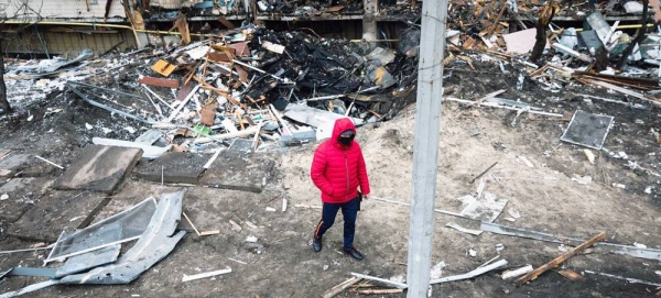 A man walks in front of a crater left by an explosion during escalating conflict in Kiev, Ukraine. — courtesy UNICEF/Anton Skyba for The Globe and Mail