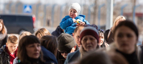 At the border crossing between Ukraine and Moldova at Palanca, refugees stand in line.