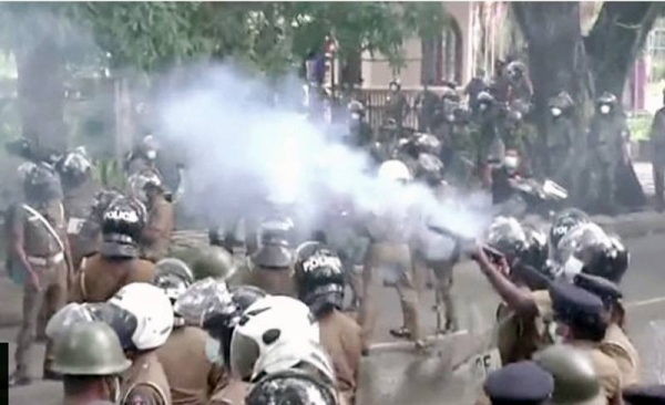 Police in Sri Lanka fire tear gas and water cannon at protesters in Kandy.